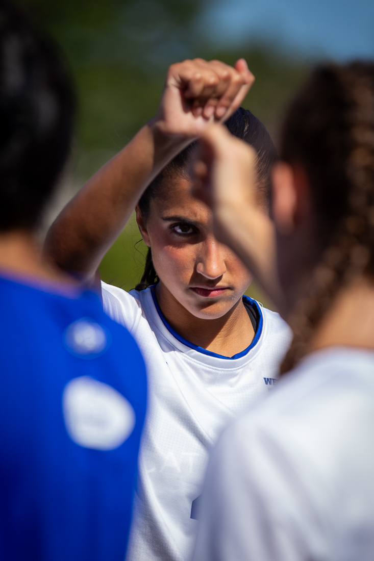 Female Soccer player stares at camera.
