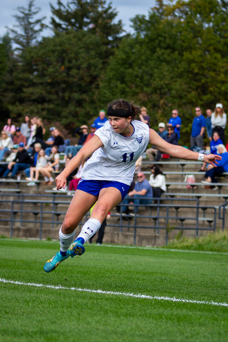 A soccer player in mid-kick.